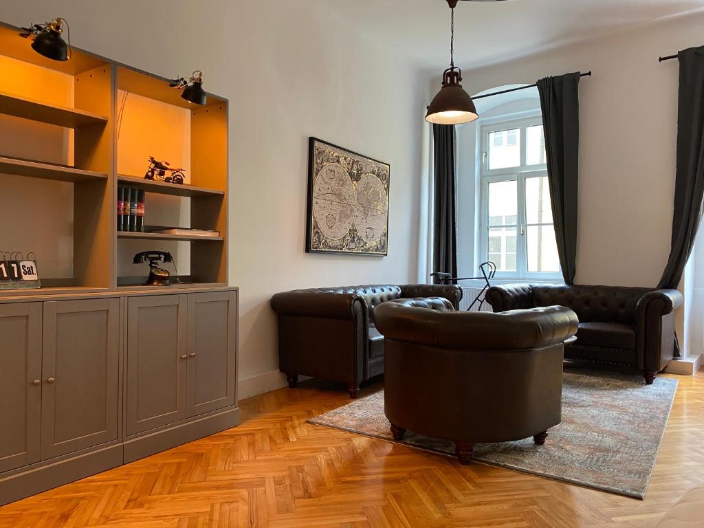 een woonkamer met een bank en een stoel bij Industrial Apartment Schlossberg in Linz