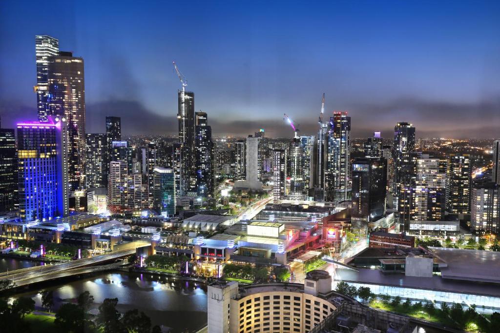 a view of a city at night with at Orange Stay at Melbourne Quarter in Melbourne