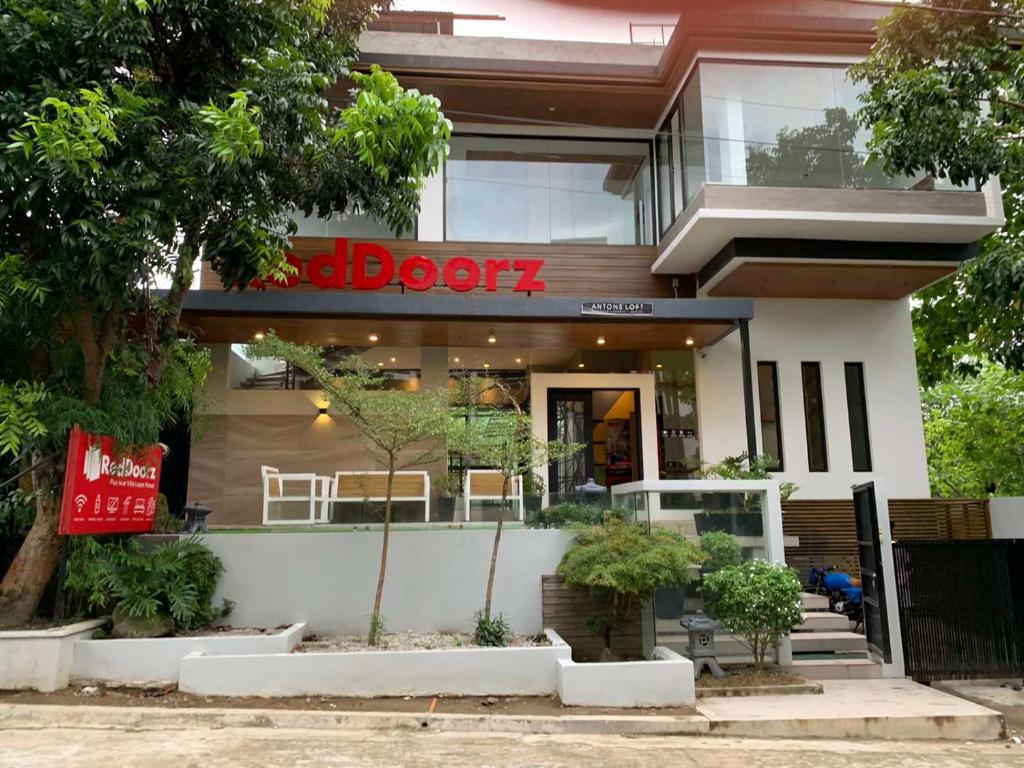 a store front of a building with a sign on it at RedDoorz at Anton's Loft Designer Resort Pansol Calamba Laguna in Laguna