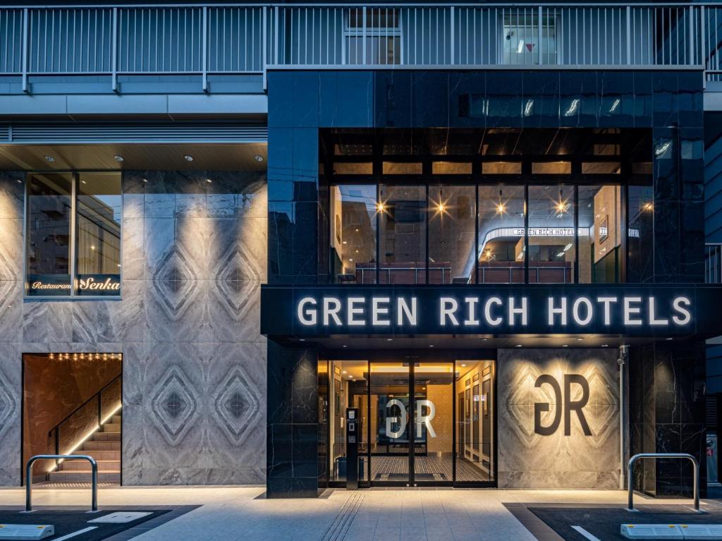 a building with a green rich hotels sign on it at Green Rich Hotel Kobe Sannomiya (Artificial hot spring Futamata Yunohana) in Kobe