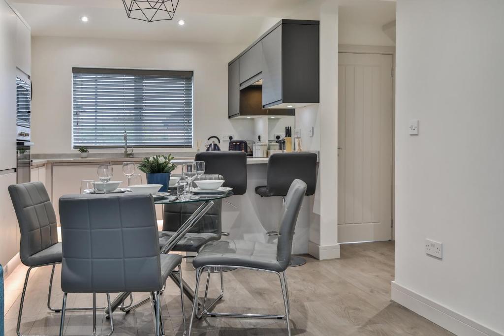 a kitchen and dining room with a table and chairs at Magnificent, Renovated Whole House with Parking by Ark SA in Sheffield