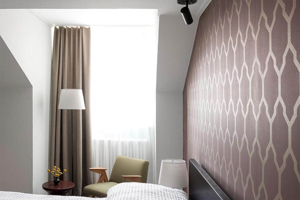 Postel nebo postele na pokoji v ubytování ADLER Boutique Hotel