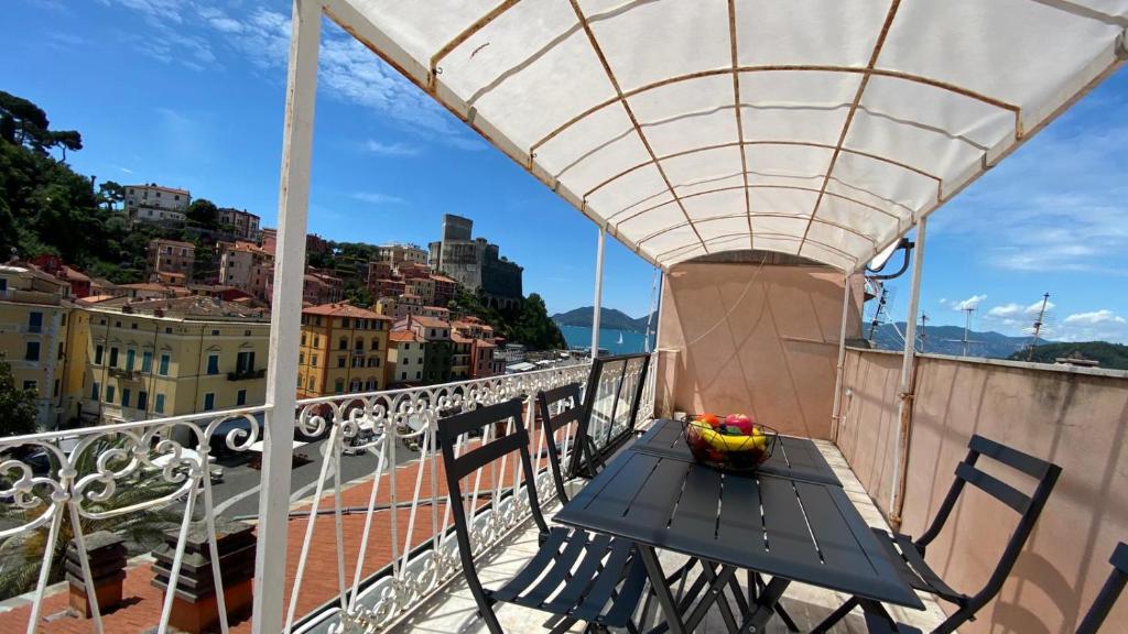 a table with a bowl of fruit on a balcony at Square views in Lerici