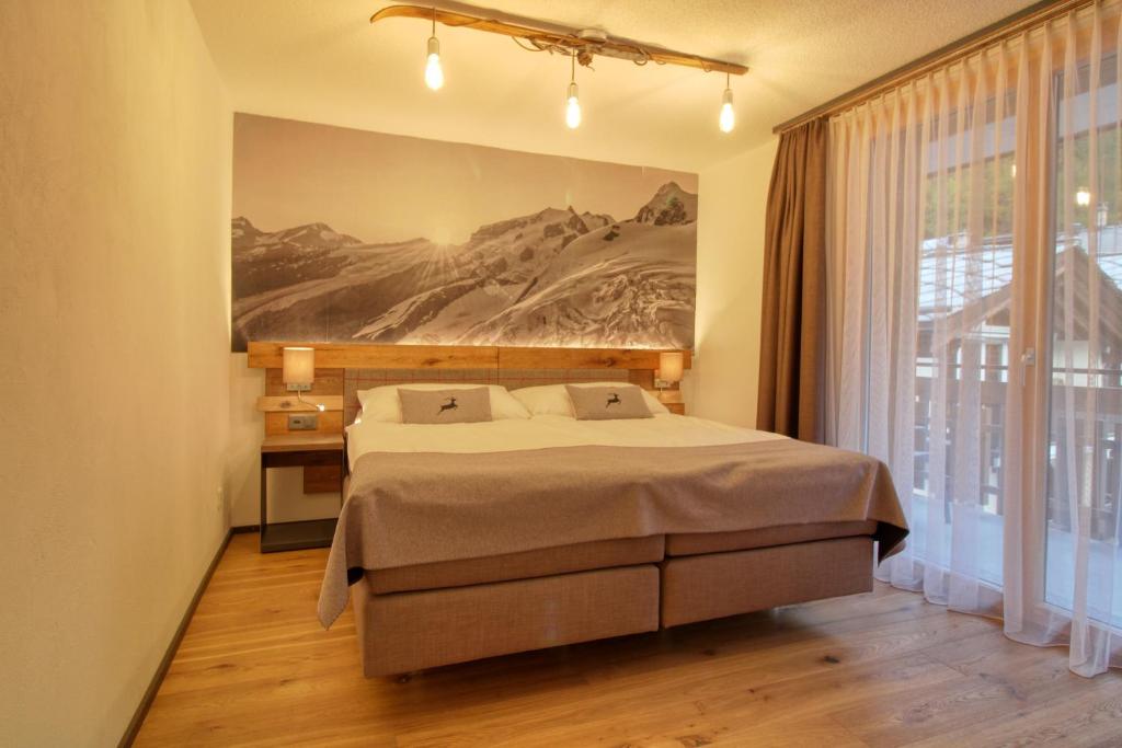 Postel nebo postele na pokoji v ubytování Matterhorngruss Apartments