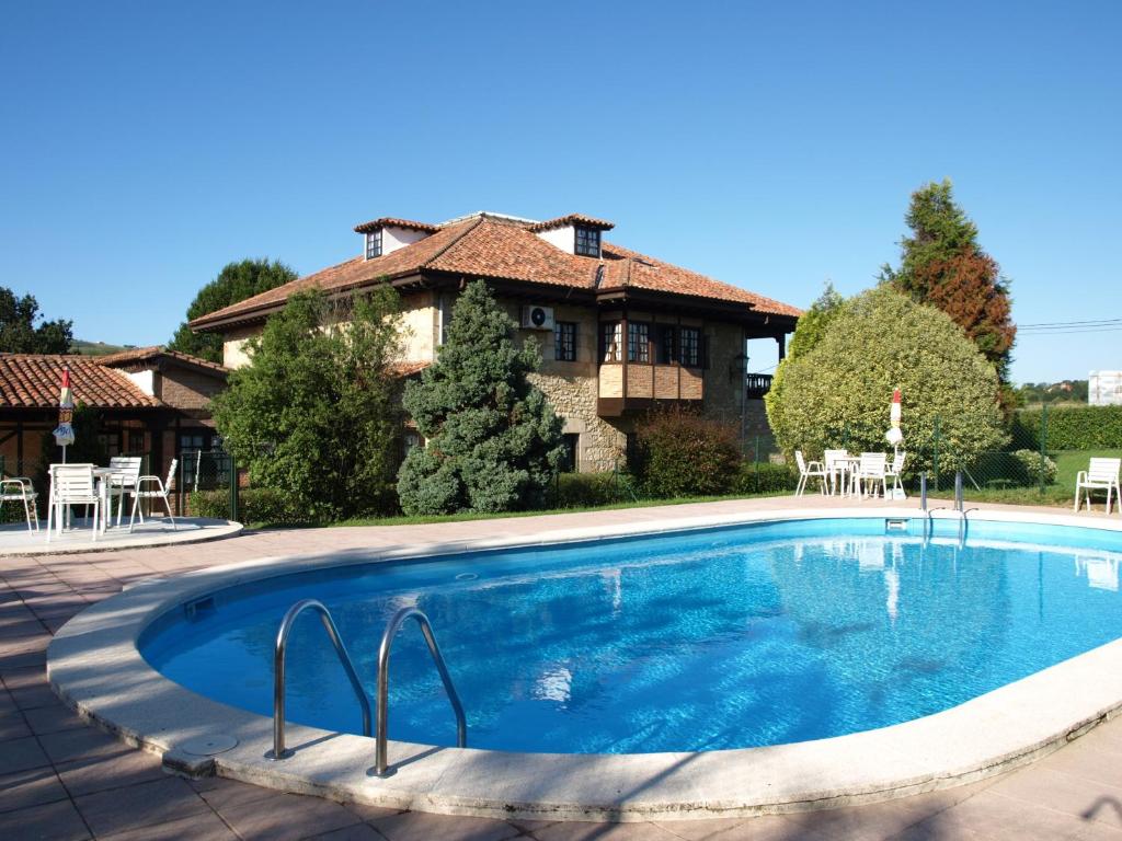 a swimming pool in front of a house at Hotel Siglo XVIII in Santillana del Mar