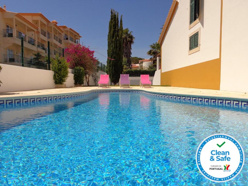 a swimming pool in a villa with blue water at Noly by Check-in Portugal in Albufeira