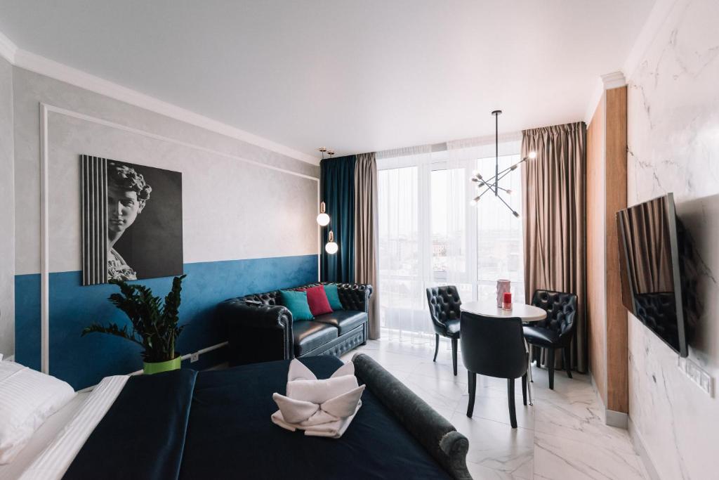 a bedroom with a bed and a living room at Royal Tower VIP Smart Apartments 3 in Kyiv