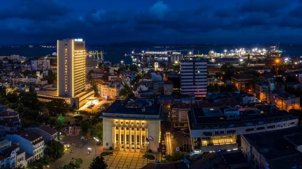 a view of a city at night at Hotel Bulgaria in Burgas City