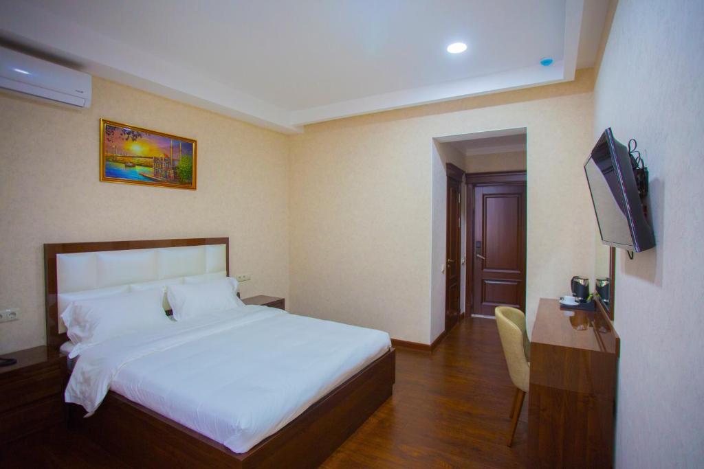 Postel nebo postele na pokoji v ubytování HOTEL AYNI