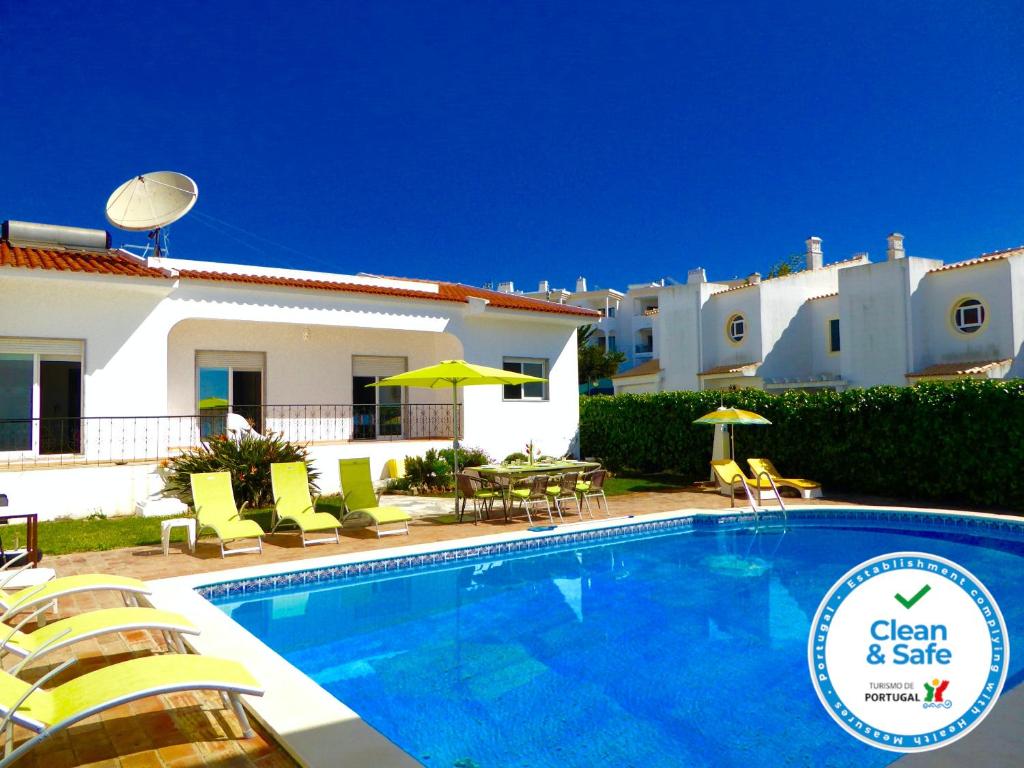 a swimming pool in front of a villa at Vital by Check-in Portugal in Albufeira