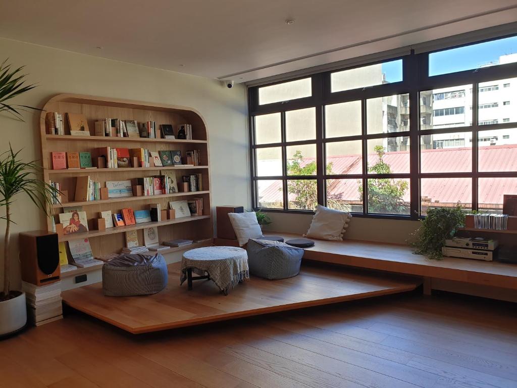 a living room with a bench in front of a window at OR Inn in Hsinchu City