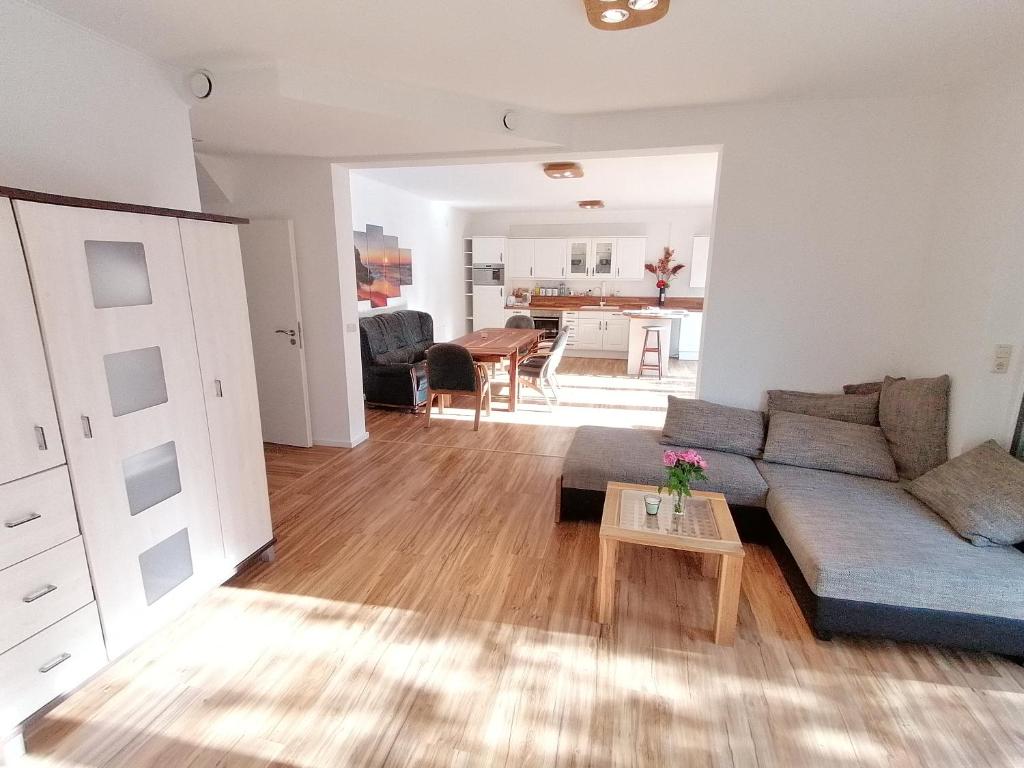 a living room with a couch and a table at 85 qm Wohnung Pauluste mit Terasse und Garten in Rostock