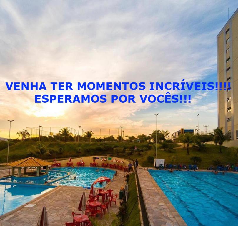 a view of a swimming pool at a resort at No GOLDEN DOLPHIN EXPRESS VOCÊ IRÁ TER MOMENTOS ESPETACULARES! in Caldas Novas