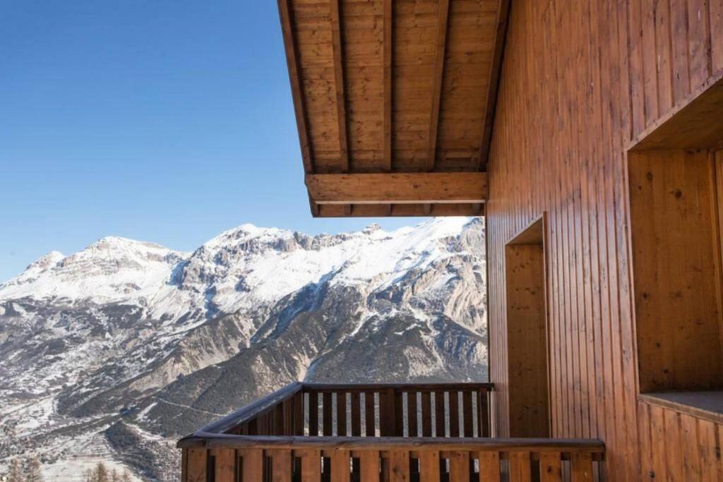 a room with a view of a mountain at Residence Les Gentianes - maeva Home in Puy-Saint-Vincent