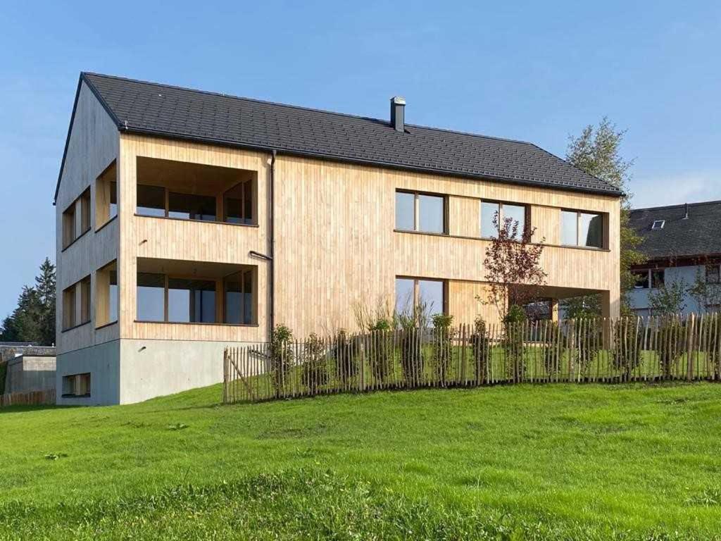 een huis met een hek voor een veld bij Apartments Pôldi in Sulzberg