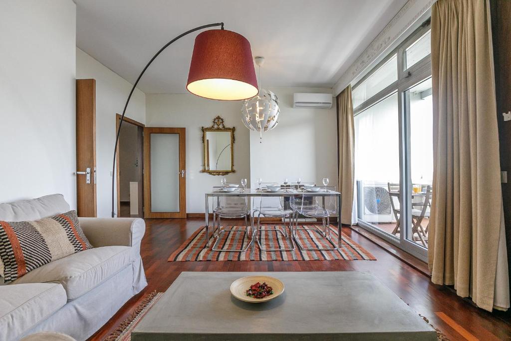 a living room with a couch and a table at LovelyStay - Spacious 3BR Flat with AC and Balcony in Porto