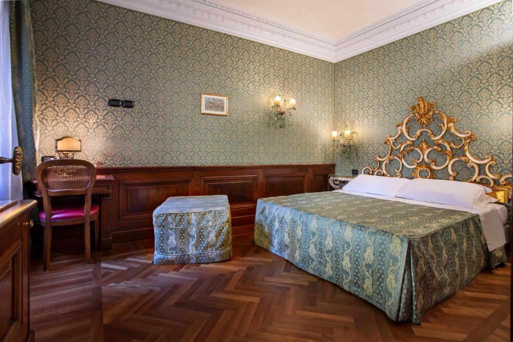 Łóżko lub łóżka w pokoju w obiekcie Palazzina Veneziana