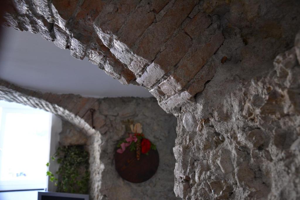 a brick wall with a vase on top of it at B&B Torre Porta Marina in Ventimiglia
