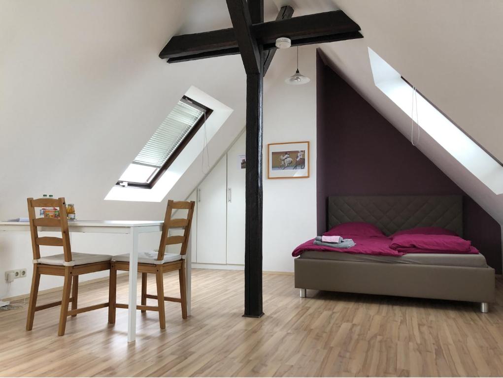 a bedroom with a bed and a table and chairs at Einzel-Apartment Düsseldorf Oberkassel in Düsseldorf