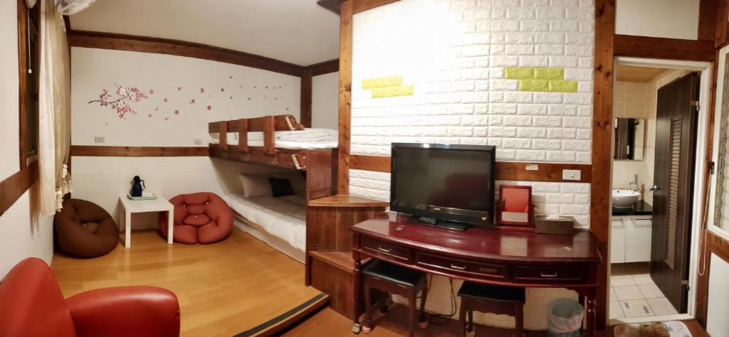 a living room with a television and bunk beds at Share B&amp;B in Puli