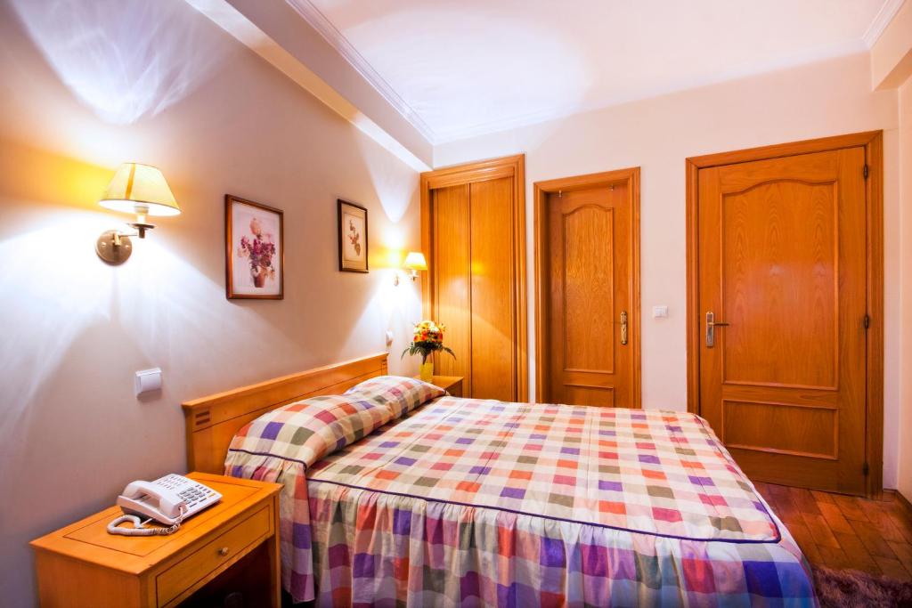Postel nebo postele na pokoji v ubytování Residencial Colombo