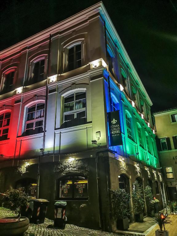 a building with colored lights on the side of it at Roma Luxus Hotel in Rome