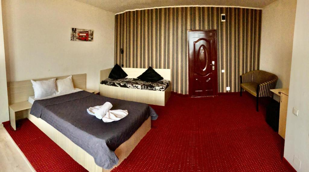 Postel nebo postele na pokoji v ubytování Hotel Mon Caprice