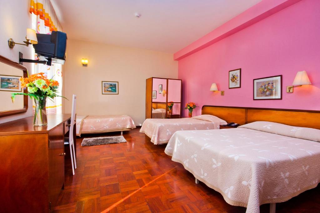 Postel nebo postele na pokoji v ubytování Residencial Colombo