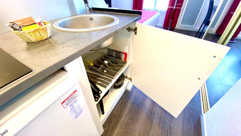 a bathroom with a sink and a counter top at Boulogne Résidence Hotel in Boulogne-Billancourt