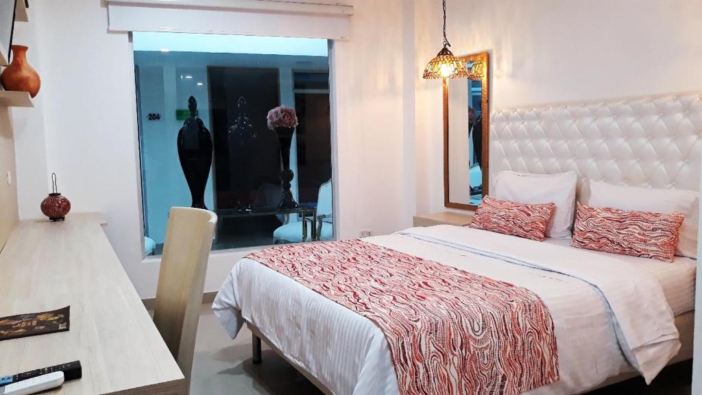 Säng eller sängar i ett rum på Hotel Boutique El Poblado