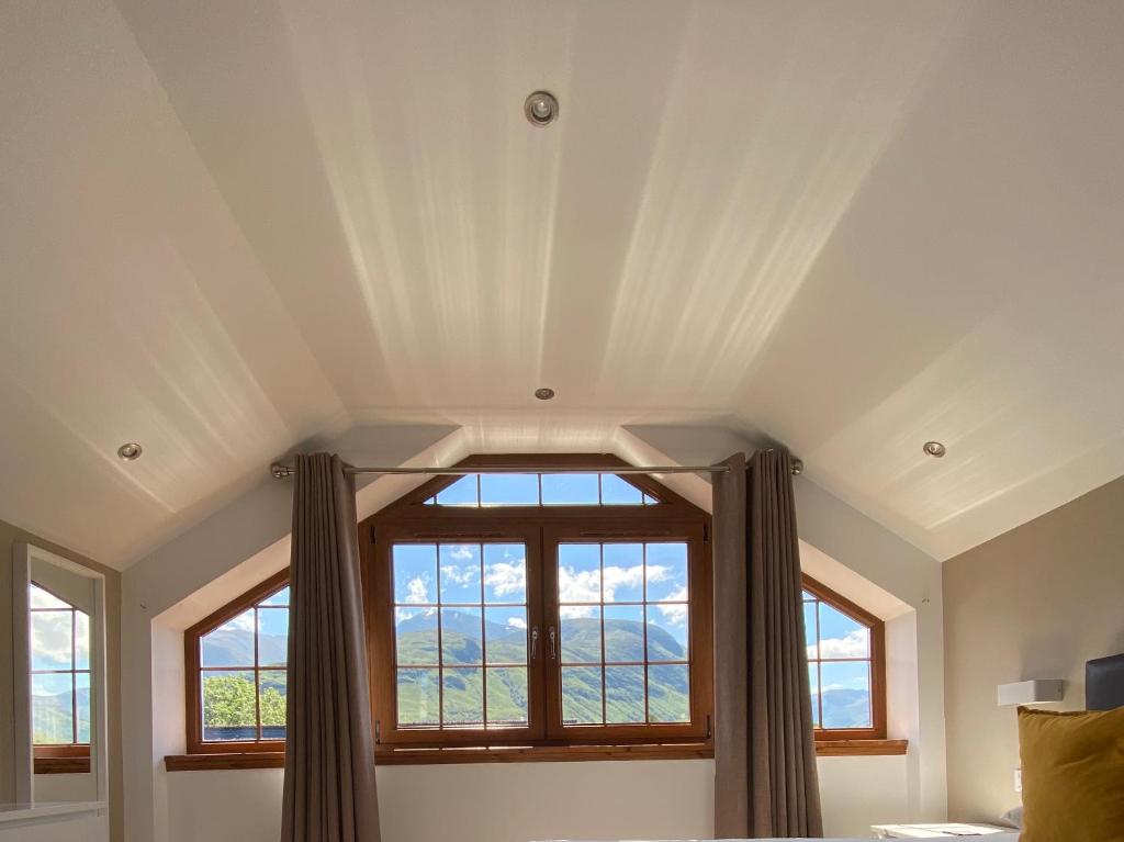 a bedroom with a large window in the ceiling at 3 Sheraton Apartments in Fort William