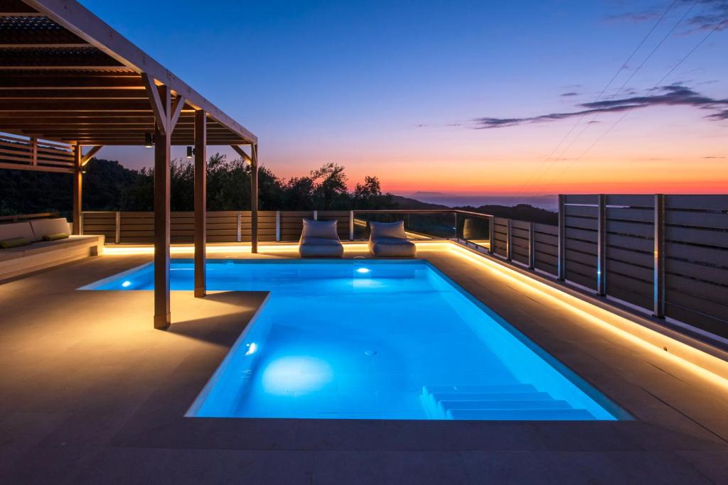 a swimming pool on the roof of a house at Villa Corfu Melody in Vouníon