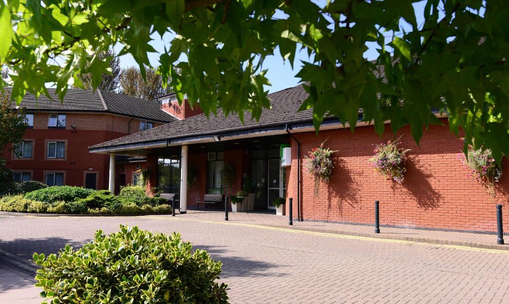 a red brick building on a street at Holiday Inn Telford Ironbridge, an IHG Hotel in Telford