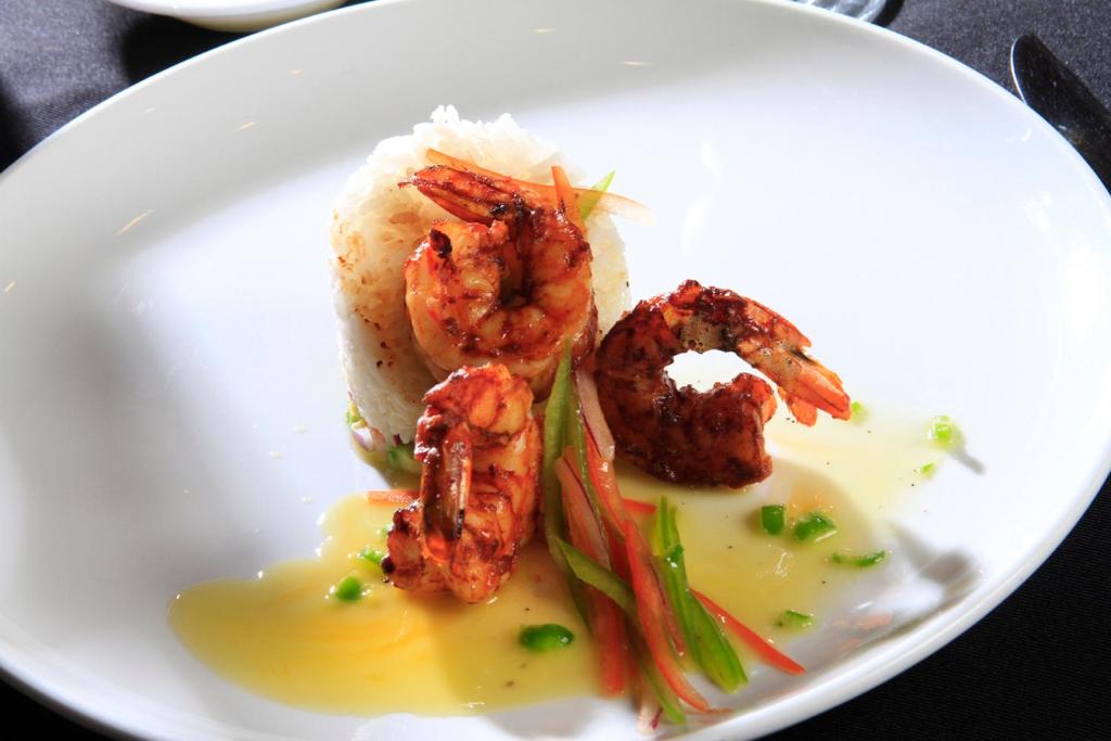a plate of food with shrimp and vegetables on it at Holiday Inn Monterrey-Parque Fundidora by IHG in Monterrey