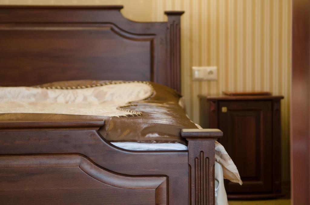 Postel nebo postele na pokoji v ubytování Naftusya Hotel