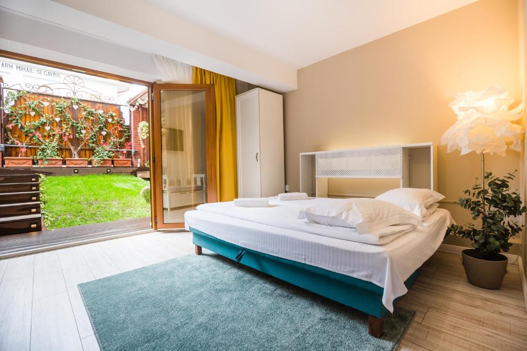 a bedroom with a large bed and a large window at Villa V in Braşov