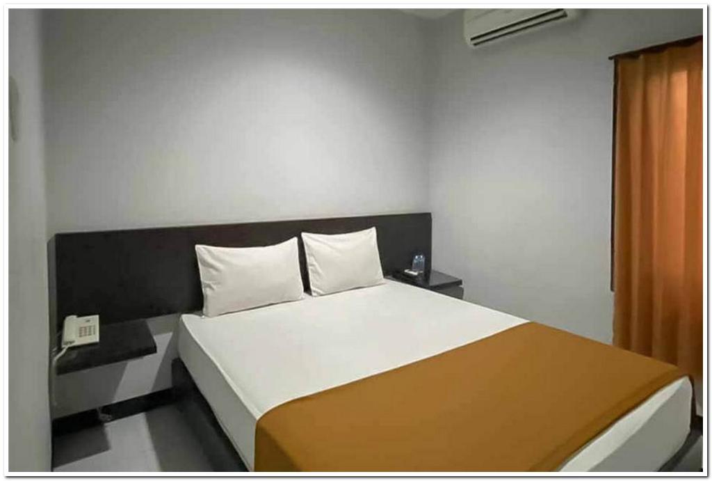 מיטה או מיטות בחדר ב-Losmen Family Syariah Bypass Juanda Mitra RedDoorz