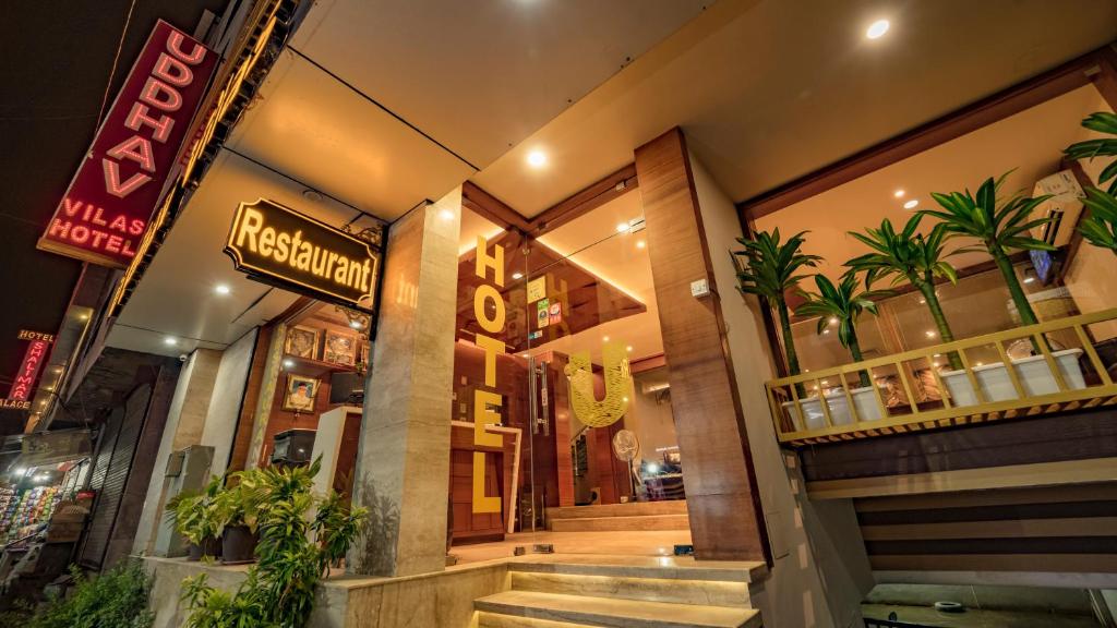 a restaurant with stairs leading to the front door at Uddhav Vilas A Family Hotel in Udaipur