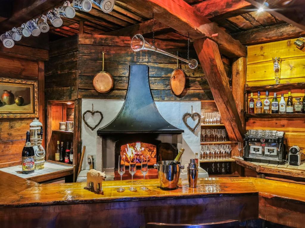 a bar with a fireplace in a room at Chez Bear in Briançon