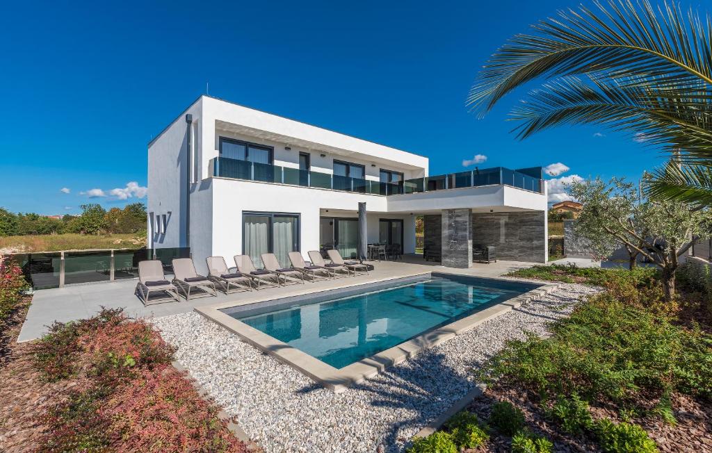 uma grande casa branca com uma piscina em frente em Villa Sandi em Novigrad Istria
