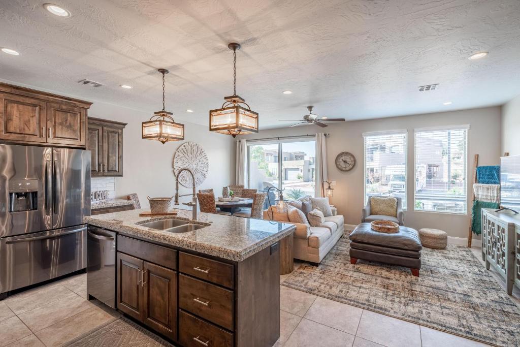 a kitchen with a counter top and a living room at Hoodoo Haute in St. George