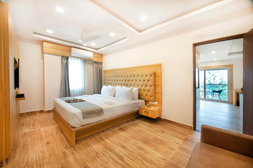 a bedroom with a large bed and a mirror at ABM Boutique Hotel by Purple Cloud in Bangalore