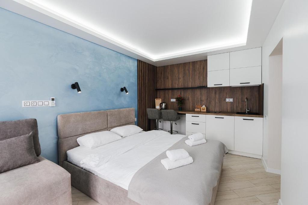 a bedroom with a large bed and a couch at CityApartments Kyiv Palace "Ukraine" in Kyiv