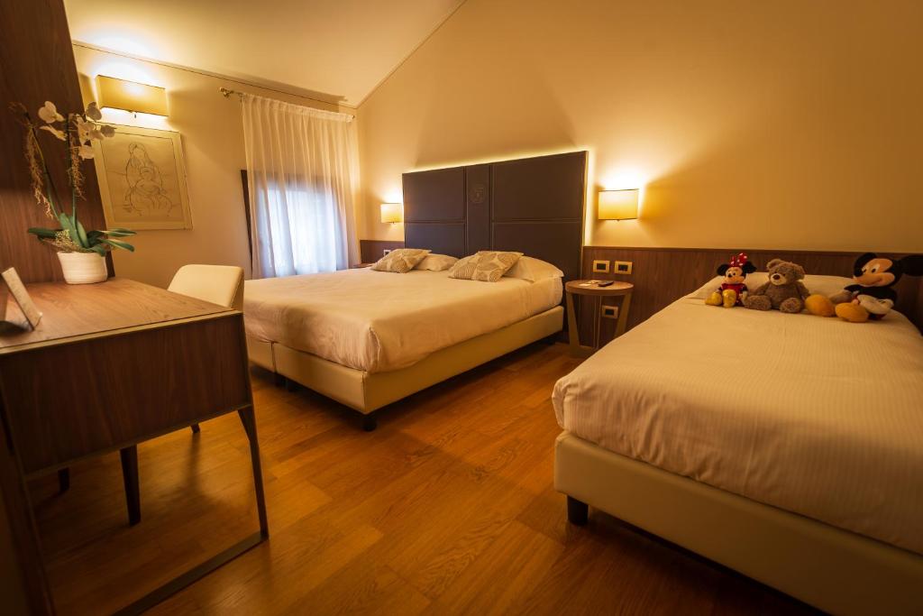Postel nebo postele na pokoji v ubytování Hotel Alla Torre