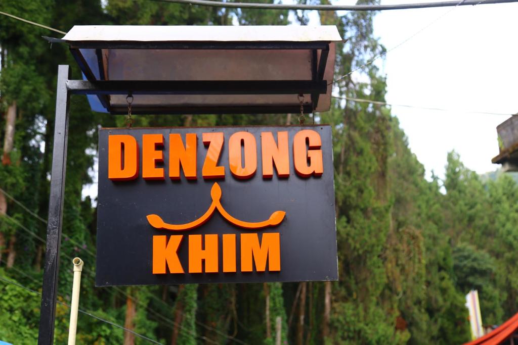 a sign for a demongling khim on a pole at Denzong Khim in Gangtok