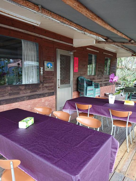 a group of tables and chairs with purple table cloth at Jinguang Homestay in Fanlu