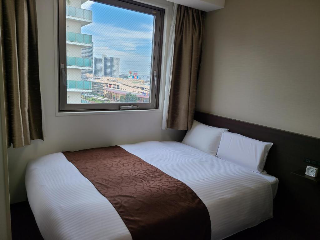 Postel nebo postele na pokoji v ubytování AI HOTEL Hashimoto