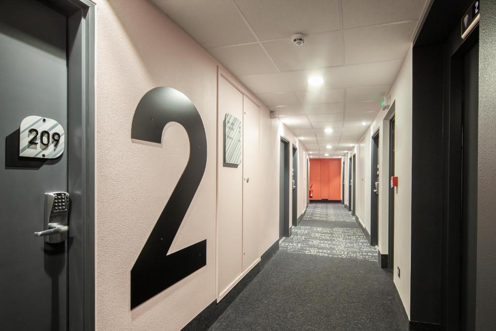 a hallway with a number on the wall at B&B HOTEL Ouistreham in Ouistreham