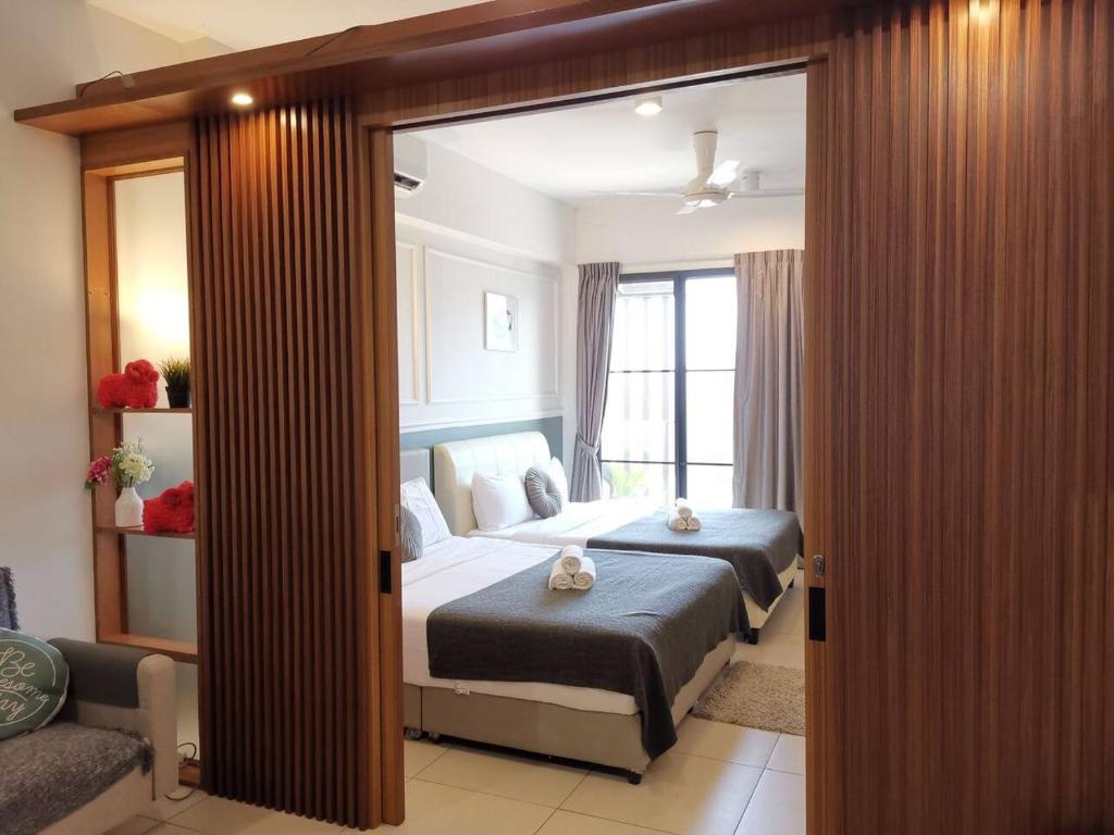 a bedroom with a bed and a large mirror at Midhill Service Aparment Genting Highlands in Genting Highlands