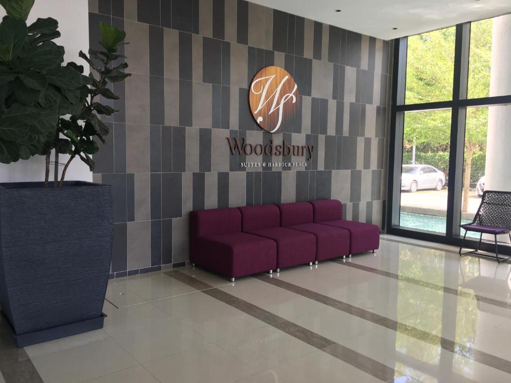 a couch in a lobby with a sign on the wall at Woodsbury by Micheal Butterworth Penang 7722 in Butterworth